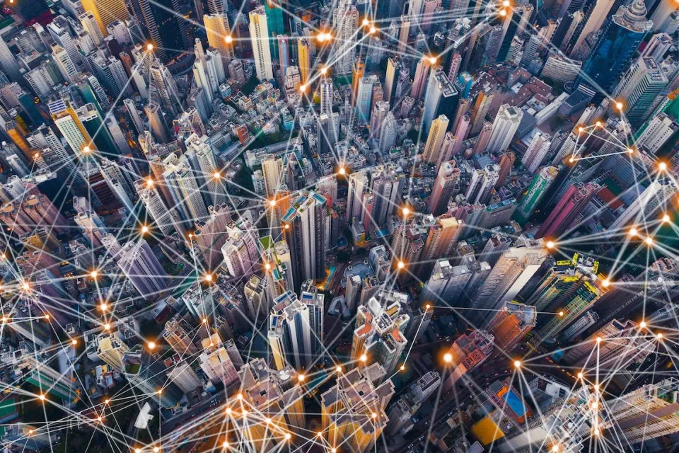 Aerial view of dense urban center with lines indicating smart city concept.